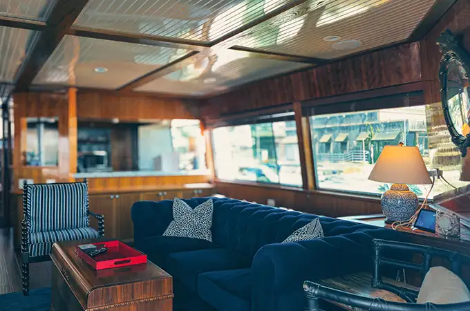 Remodeled yacht interior lounge with blue couch