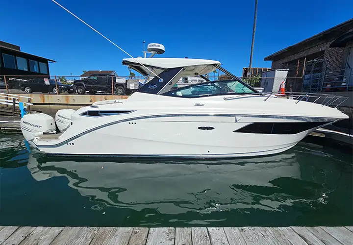 Full side profile of the Sea Ray at the dock