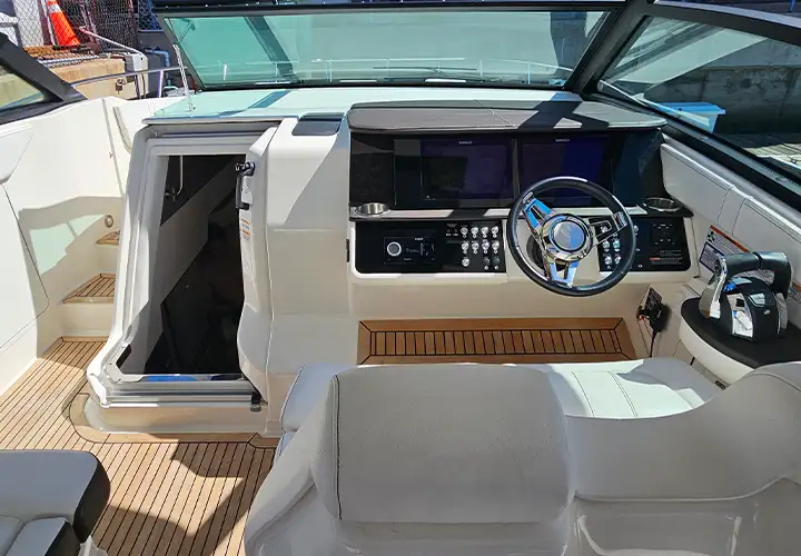 Captain seating beside the helm and the open cabin entrance