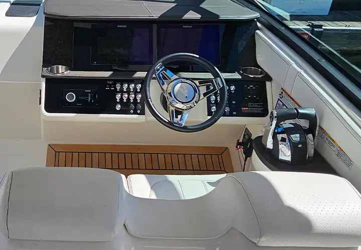 Close view of the Sea Ray steering wheel, controls and navigation displays